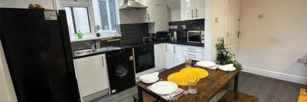 a tidy kitchen and living area for supported living